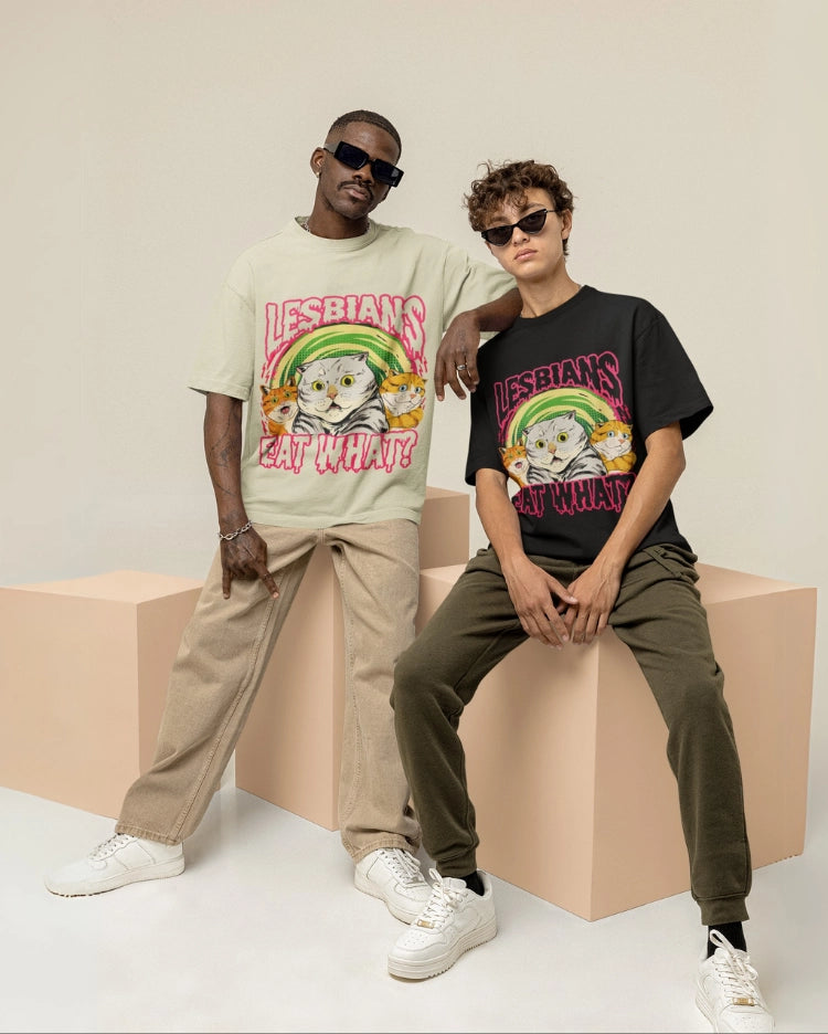 Two people wearing t-shirts with a graphic design and text, sitting on geometric blocks.