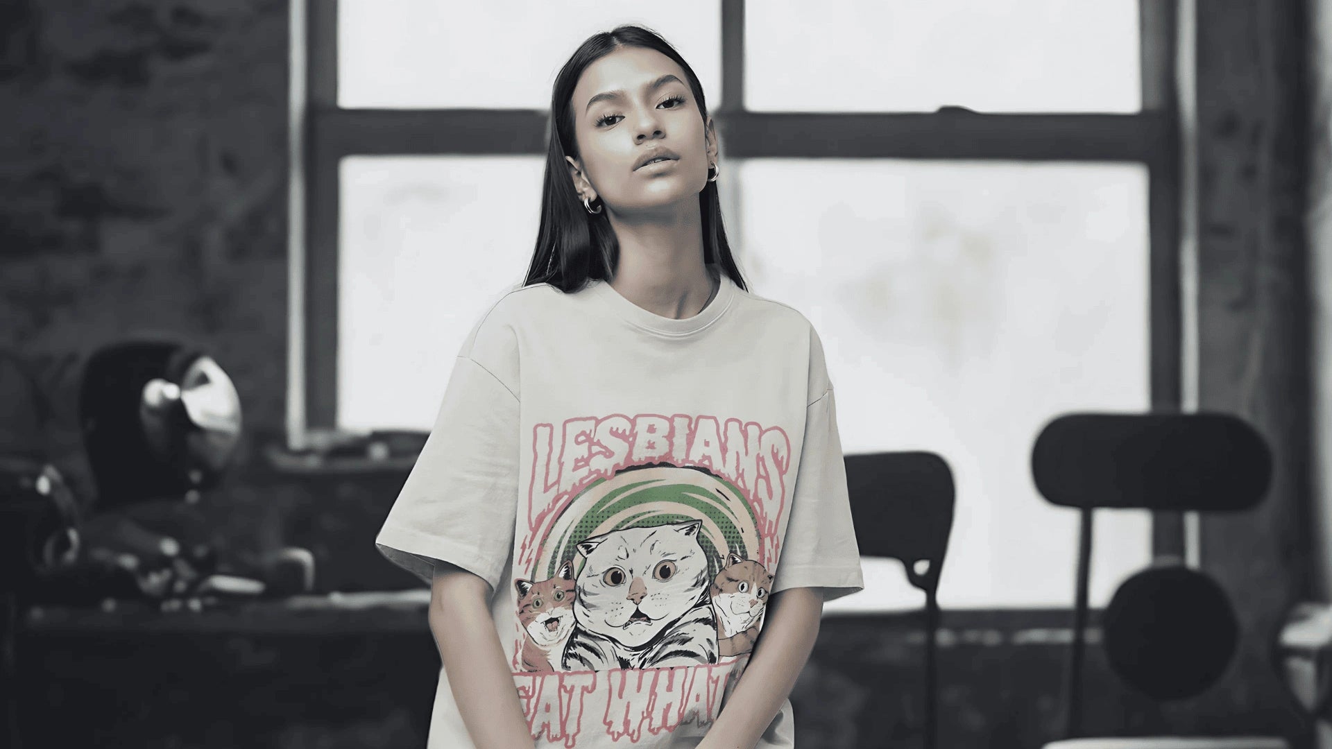 Person wearing a t-shirt with graphic design and text in an indoor setting