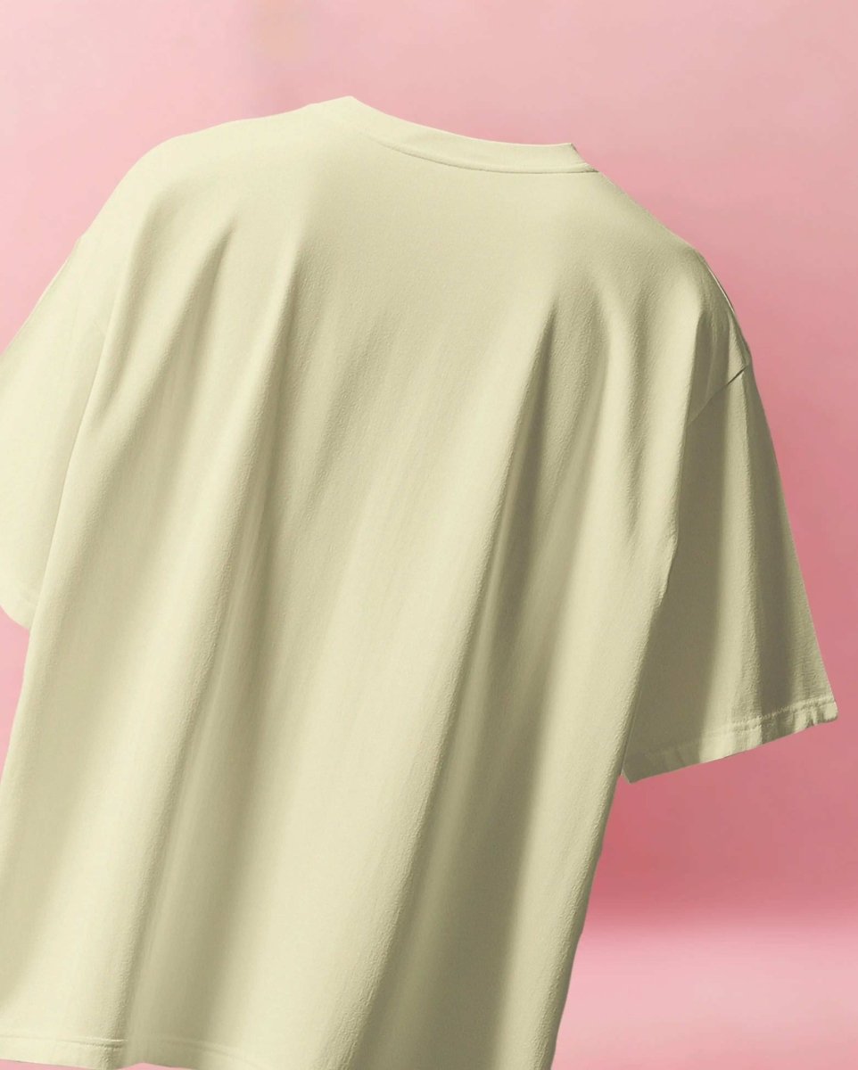 Back view of Sabrina Carpenter Give-a-Fucks Oversized T-shirt in light beige with relaxed fit on pink background